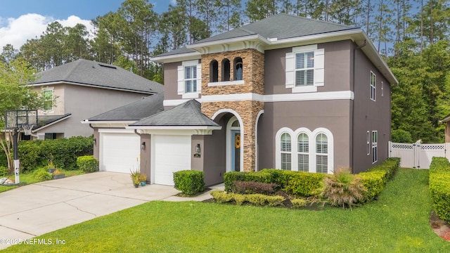 184 Rockcreek Dr, Saint Johns, FL 32259 - view of front facade featuring stone siding, stucco siding, concrete driveway, an attached garage, and a shingled roof