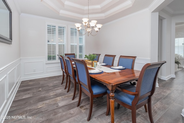 184 Rockcreek Dr, Saint Johns, FL 32259 - dining space featuring a chandelier, wood finished floors, a tray ceiling, crown molding, and a decorative wall
