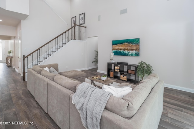 184 Rockcreek Dr, Saint Johns, FL 32259 - living room featuring a towering ceiling, stairway, dark wood-style floors, and baseboards