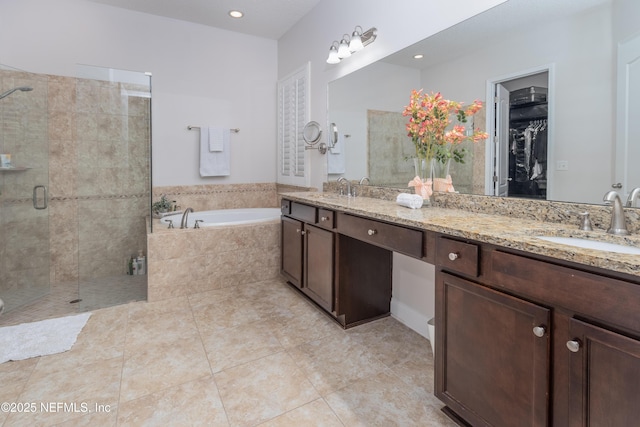 184 Rockcreek Dr, Saint Johns, FL 32259 - full bathroom with double vanity, a garden tub, a shower stall, tile patterned flooring, and a walk in closet
