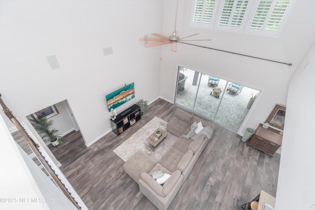 184 Rockcreek Dr, Saint Johns, FL 32259 - living room featuring a towering ceiling, healthy amount of natural light, wood finished floors, a ceiling fan, and baseboards