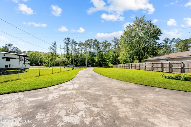 view of street with concrete driveway