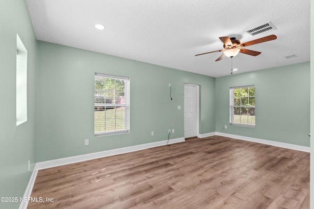 empty room featuring visible vents, baseboards, ceiling fan, recessed lighting, and wood finished floors