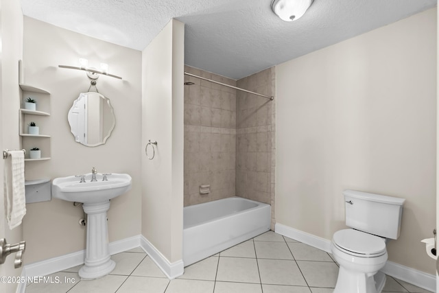 full bath with toilet, a textured ceiling, and tile patterned floors