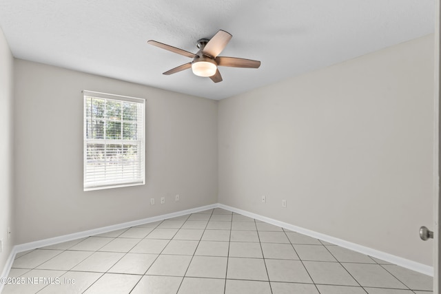 unfurnished room featuring light tile patterned floors, baseboards, and ceiling fan