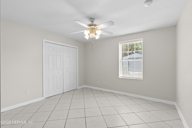 unfurnished bedroom featuring a closet, baseboards, and a ceiling fan