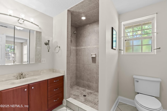 bathroom featuring a wealth of natural light, a tile shower, and toilet