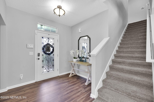 3699 Summit Oaks Dr, Green Cove Springs, FL 32043 - entrance foyer with a textured ceiling, wood finished floors, baseboards, and stairs