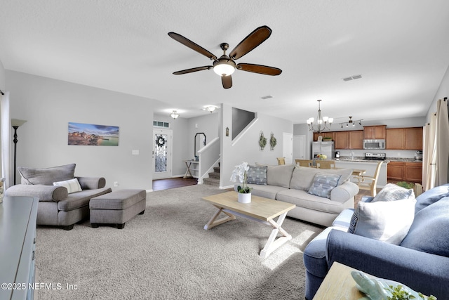 3699 Summit Oaks Dr, Green Cove Springs, FL 32043 - living area featuring visible vents, stairway, carpet floors, and ceiling fan with notable chandelier