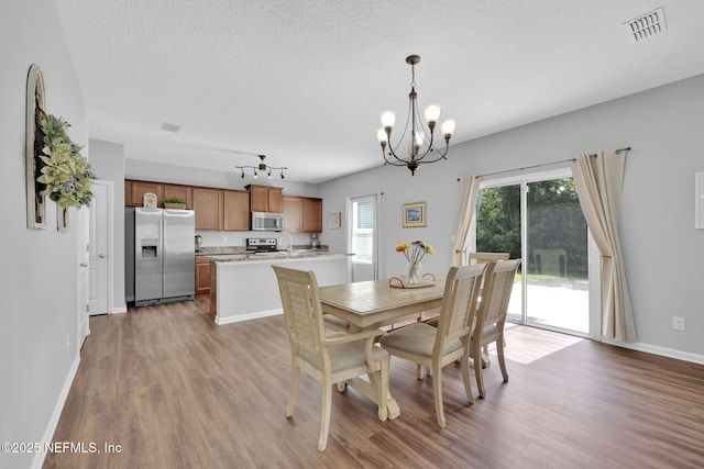 3699 Summit Oaks Dr, Green Cove Springs, FL 32043 - dining area featuring dark wood-style flooring, visible vents, a chandelier, and a textured ceiling