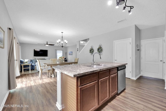 3699 Summit Oaks Dr, Green Cove Springs, FL 32043 - kitchen with ceiling fan with notable chandelier, stainless steel dishwasher, visible vents, wood finished floors, and a sink