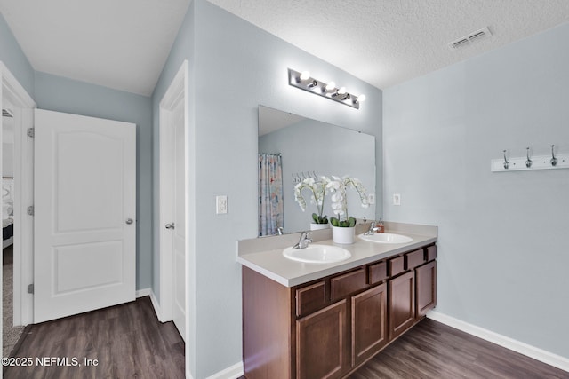 3699 Summit Oaks Dr, Green Cove Springs, FL 32043 - full bath with a sink, visible vents, and wood finished floors