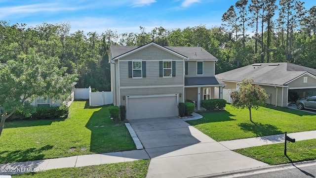 3699 Summit Oaks Dr, Green Cove Springs, FL 32043 - traditional home featuring an attached garage, concrete driveway, fence, and a front lawn
