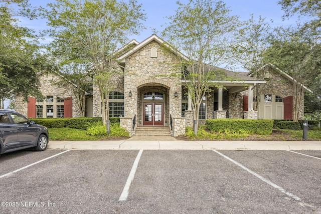 3699 Summit Oaks Dr, Green Cove Springs, FL 32043 - view of front of house with uncovered parking, french doors, and stone siding
