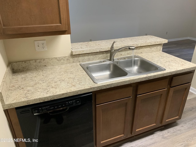 5473 Pinehaven Ct, Jacksonville, FL 32244 - kitchen featuring baseboards, dishwasher, a sink, light countertops, and light wood-style flooring