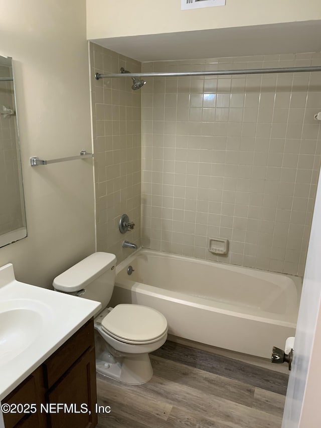 5473 Pinehaven Ct, Jacksonville, FL 32244 - full bathroom with toilet, wood finished floors, vanity, and washtub / shower combination