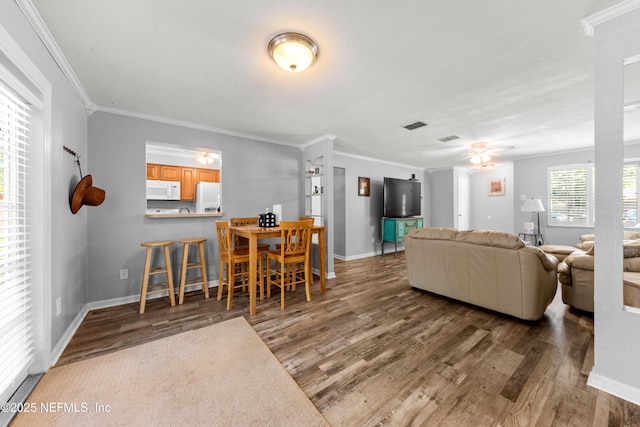 1648 Rhonda Dr, Middleburg, FL 32068 - living room featuring baseboards, ornamental molding, a ceiling fan, visible vents, and wood finished floors