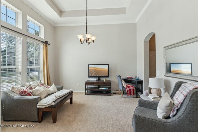 244 W Berkswell Dr, Saint Johns, FL 32259 - living area with crown molding, carpet, a tray ceiling, arched walkways, and a chandelier