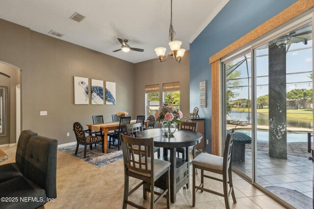 244 W Berkswell Dr, Saint Johns, FL 32259 - dining area with arched walkways, light tile patterned floors, visible vents, and ceiling fan with notable chandelier