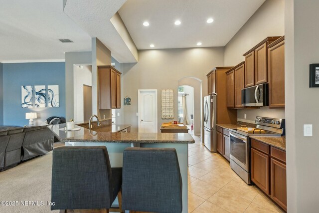 244 W Berkswell Dr, Saint Johns, FL 32259 - kitchen with open floor plan, visible vents, a kitchen bar, stainless steel appliances, and arched walkways