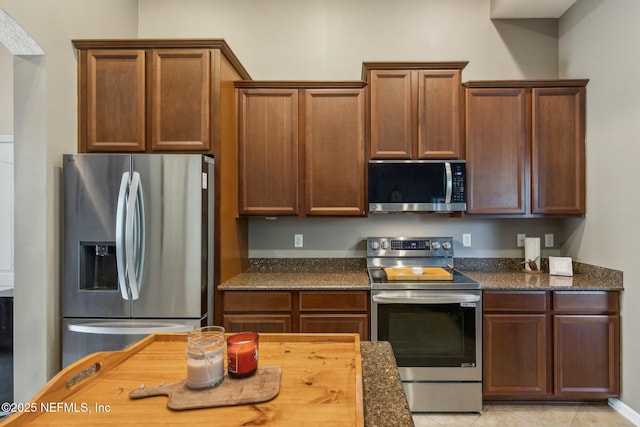 244 W Berkswell Dr, Saint Johns, FL 32259 - kitchen featuring appliances with stainless steel finishes, light tile patterned flooring, and dark stone counters