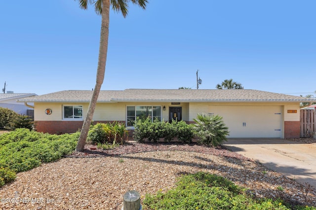 16 San Jose Cir, Ormond Beach, FL 32176 - ranch-style house featuring a garage, driveway, and brick siding