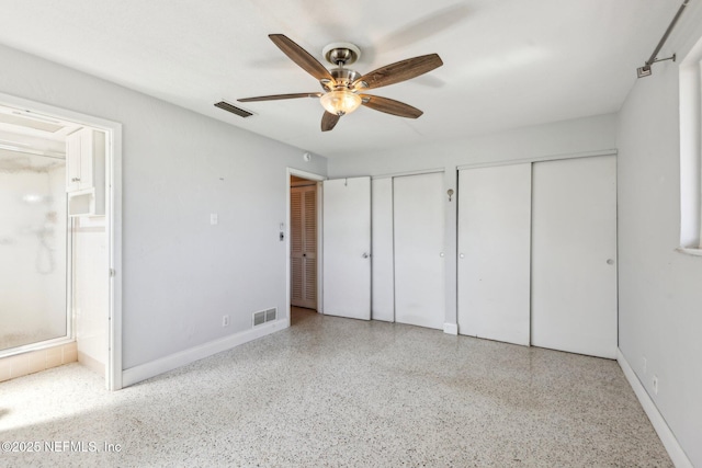 16 San Jose Cir, Ormond Beach, FL 32176 - unfurnished bedroom featuring multiple closets, baseboards, speckled floor, and visible vents