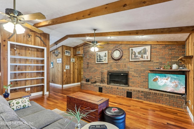 5822 Silver Sands Cir, Keystone Heights, FL 32656 - living area featuring baseboards, wooden walls, a ceiling fan, vaulted ceiling with beams, and wood finished floors