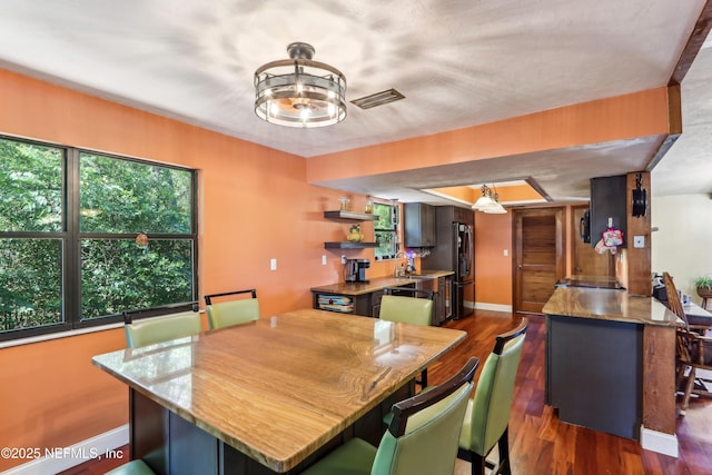 5822 Silver Sands Cir, Keystone Heights, FL 32656 - dining space featuring visible vents, dark wood finished floors, baseboards, and a healthy amount of sunlight