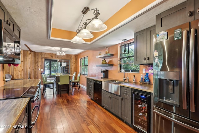 5822 Silver Sands Cir, Keystone Heights, FL 32656 - kitchen featuring open shelves, a sink, black appliances, wood-type flooring, and beverage cooler