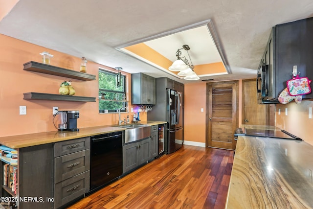 5822 Silver Sands Cir, Keystone Heights, FL 32656 - kitchen featuring dark wood-type flooring, black appliances, a sink, light countertops, and baseboards