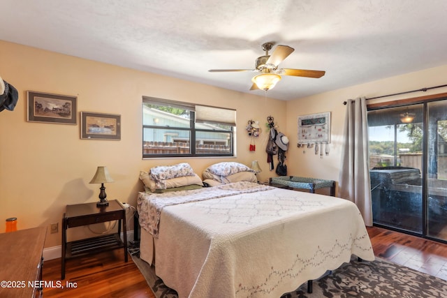5822 Silver Sands Cir, Keystone Heights, FL 32656 - bedroom with a ceiling fan, access to exterior, wood finished floors, and multiple windows