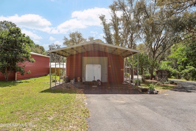 5822 Silver Sands Cir, Keystone Heights, FL 32656 - view of outbuilding featuring a carport, an outbuilding, and driveway