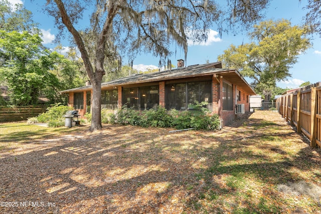 5822 Silver Sands Cir, Keystone Heights, FL 32656 - rear view of property with a chimney, fence private yard, and brick siding