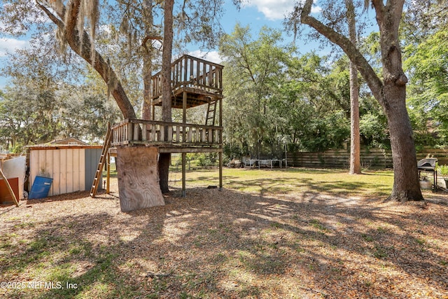 5822 Silver Sands Cir, Keystone Heights, FL 32656 - view of yard with fence, a trampoline, and a deck