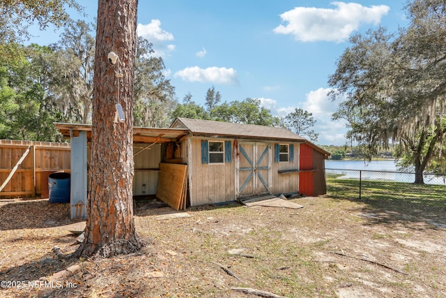 5822 Silver Sands Cir, Keystone Heights, FL 32656 - view of outdoor structure featuring a water view, fence, and an outdoor structure