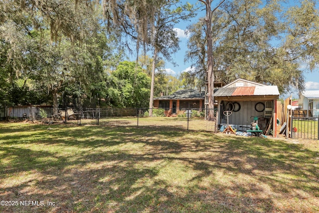 5822 Silver Sands Cir, Keystone Heights, FL 32656 - view of yard with an outbuilding, a fenced backyard, and a storage unit