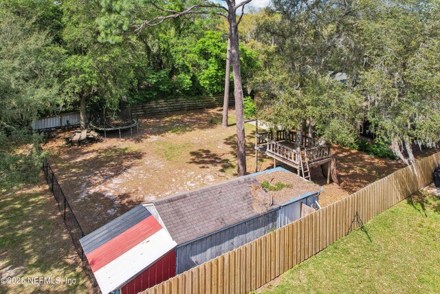 5822 Silver Sands Cir, Keystone Heights, FL 32656 - view of yard with an outdoor structure, a fenced backyard, a trampoline, and a wooden deck