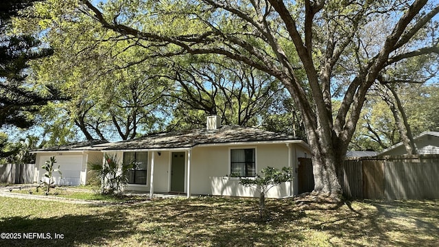 556 San Pablo Rd N, Jacksonville, FL 32225 - ranch-style house with an attached garage, a chimney, stucco siding, and fence