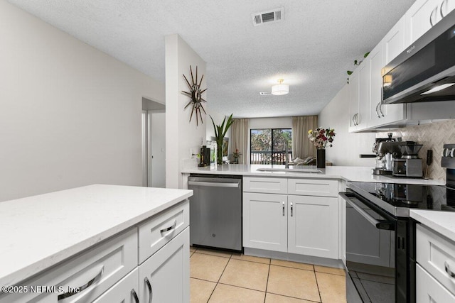 kitchen featuring white cabinetry, visible vents, a sink, light countertops, and stainless steel appliances