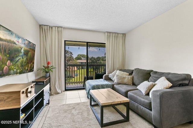 living area featuring a textured ceiling and light tile patterned flooring