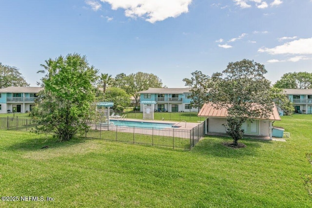 view of yard featuring a community pool and fence