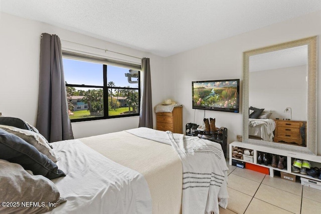 tiled bedroom with a textured ceiling
