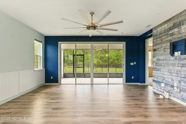 unfurnished room featuring visible vents, ceiling fan, and wood finished floors