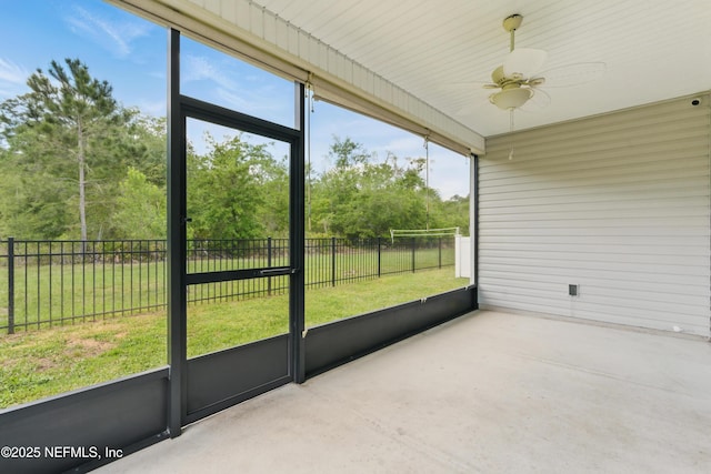unfurnished sunroom featuring ceiling fan