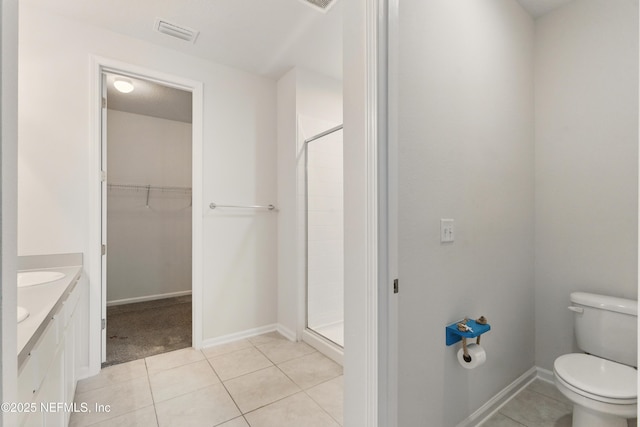 bathroom featuring a shower stall, tile patterned floors, visible vents, and toilet