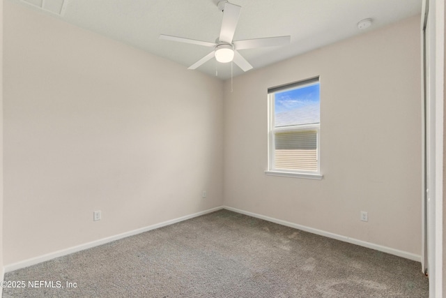 carpeted empty room with visible vents, baseboards, and ceiling fan