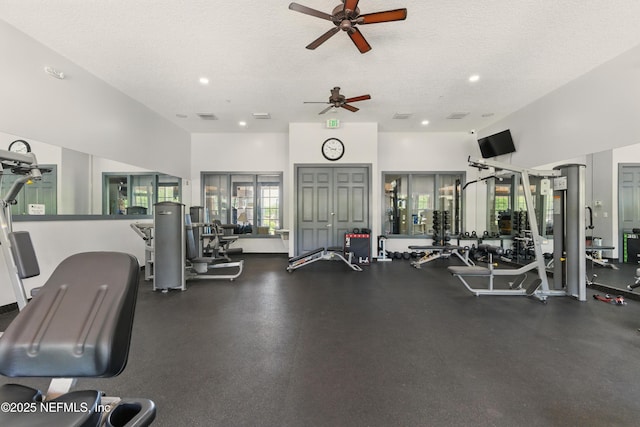 gym featuring a textured ceiling, ceiling fan, and visible vents