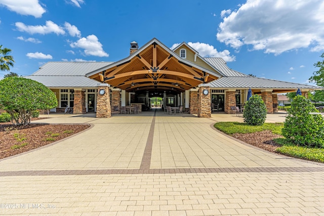 exterior space featuring curved driveway and a patio area