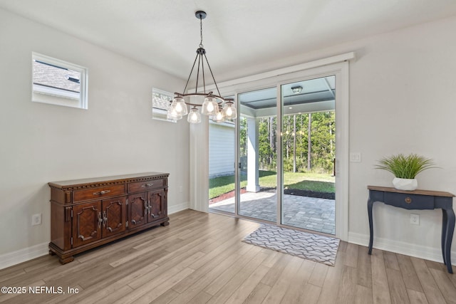 83 Woodgate Dr, Ponte Vedra, FL 32081 - dining space with light wood-type flooring, a notable chandelier, and baseboards